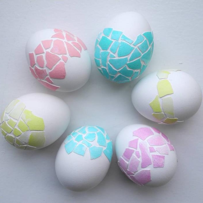 pieces of shells from colored eggs, in green pink and teal, used as decoration on white eggs