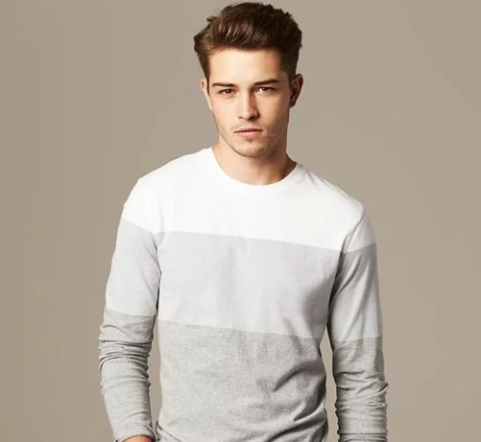 boys short haircuts, dark auburn hair, styled in a modern pompadour, and worn by young man, in grey jumper