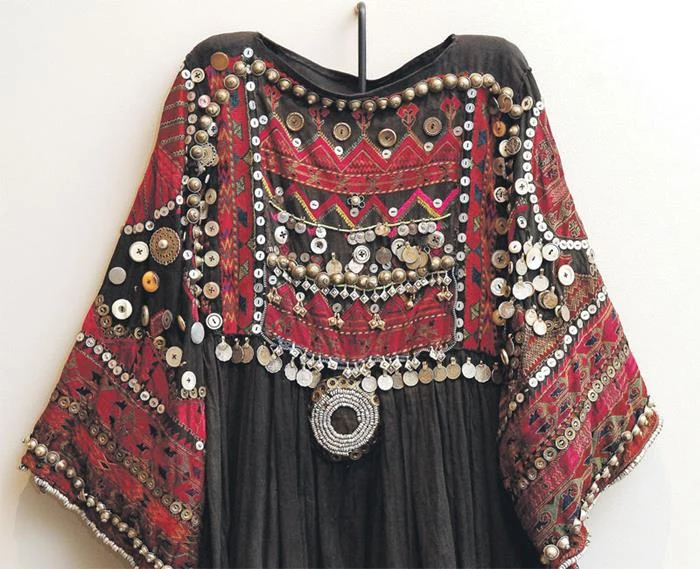 heavily embroidered black and red dress, in boho fashion, with many different beads and sequins
