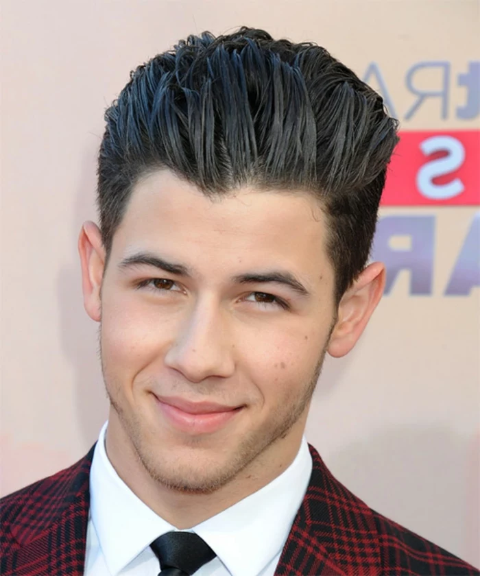 smooth black hair, with long bangs slicked back, guys haircuts, on nick jonas, wearing a red plaid blazer, white shirt and black tie
