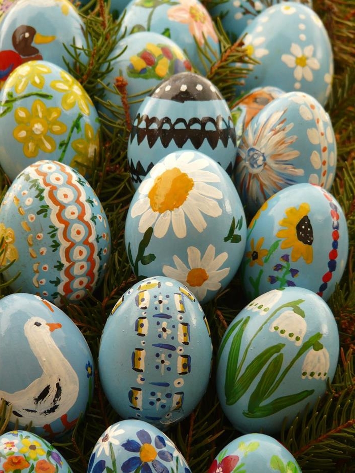 glossy blue hen's eggs, decorated with hand-painted daisies, snow drops and sunflowers, ducks and storks, easter egg ideas 