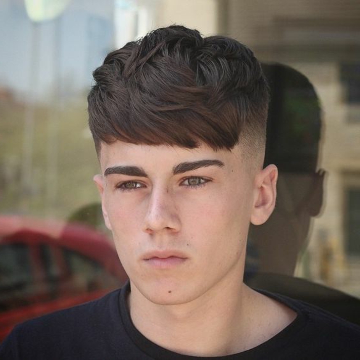 deep brown colored hair, with medium long layered bangs, and shaved sides, boys fade haircut, connected undercut