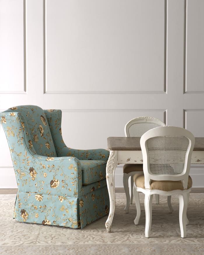 shabby sheek, armchair with pale blue fabric, decorated with grey and yellow floral pattern, near antique table in white and brown, with two matching chairs