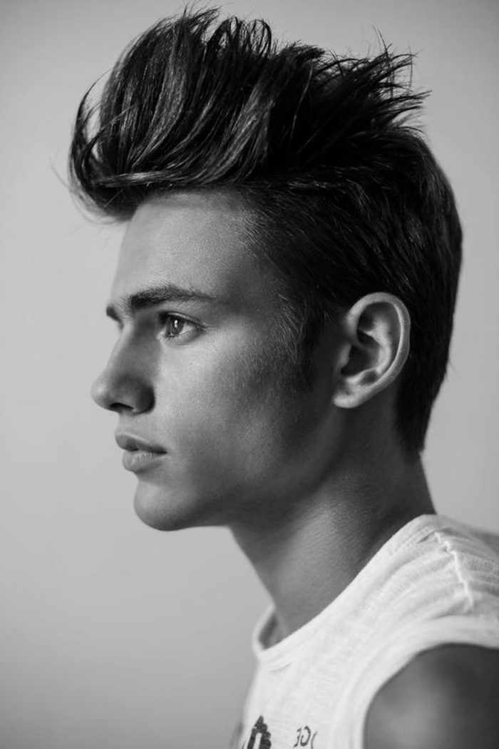 teen boy with faux hawk, wearing white tank top with graphic, looking to one side, black and white image