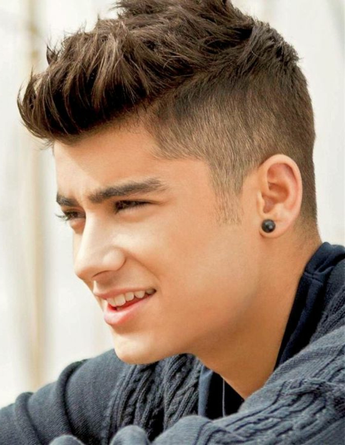 smiling zayn malik, with spiky hair and disconnected undercut, boys fade haircut, dark grey cable-knit jumper, black ear studs