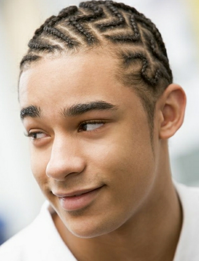 afro braids in zig zag pattern, hair designs for boys, worn by smiling young man, in white t-shirt