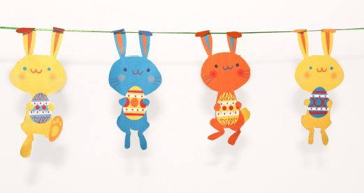 hand-crafted garland, decorated with cute yellow, orange and blue bunnies, holding painted eggs, easter crafts for adults