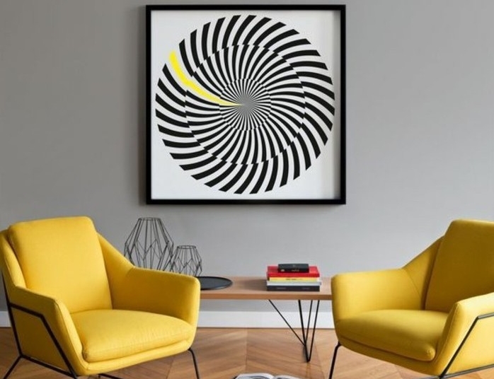 set of two modern yellow armchairs, near minimalistic light wooden table, and large framed artwork, colors that go with gray walls, modern interiors