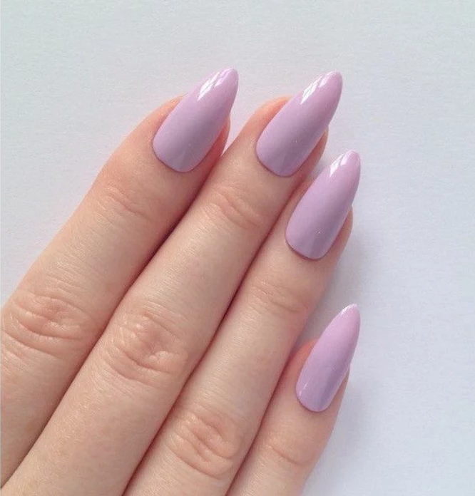 pointy nails, close up of four fingers, with sharp manicure, covered in pastel pink nail polish