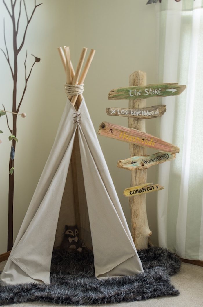 teepee or tipi, made with cream colored fabric, and wooden poles, on fluffy gray carpet, baby nursery ideas 