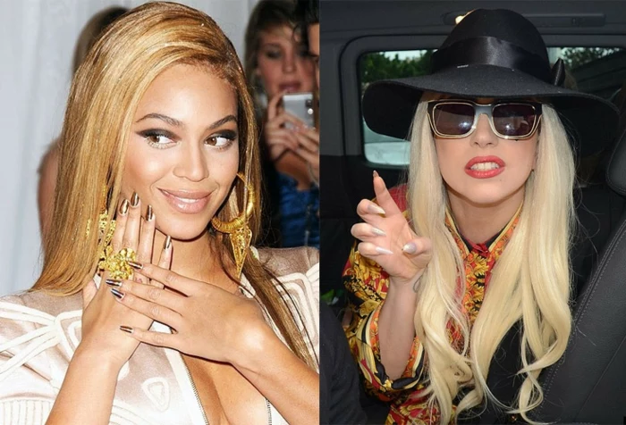 posing smiling celebrities, beyonce and lady gaga, with glamorous hair and make-up, and long pointy nails, in metallic and beige colors