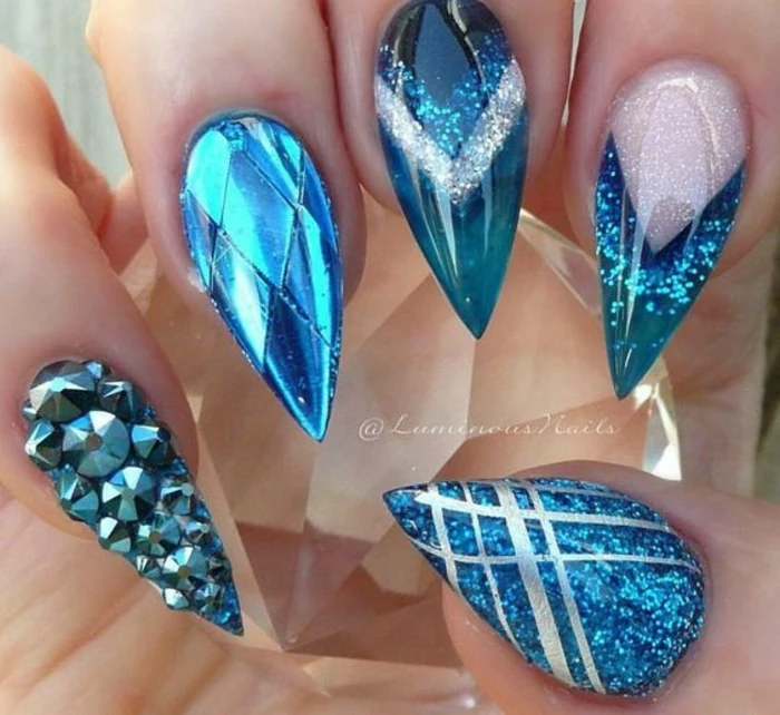 ocean blue nails, unusual and original manicure, decorated with turquoise rhinestone decals, metallic effect and silver stripes, light blue and white glitter