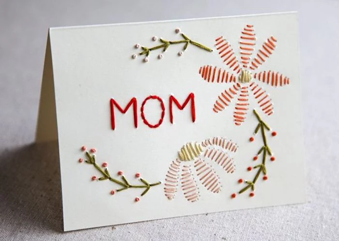 floral motives and the word mom, embroidered with red, green and yellow tread, last minute mother's day gift ideas, on white card
