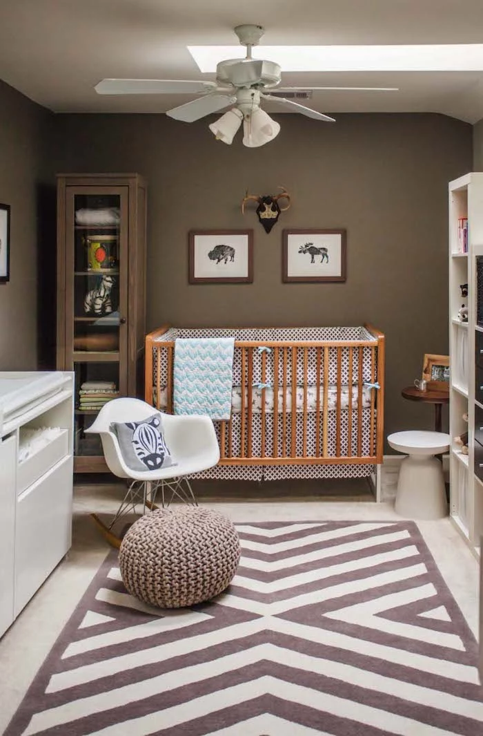 zebra cushion on white rocking chair, near pale brown wooden crib, with white and blue bedding, boys room ideas, brown walls and a ceiling fan lamp
