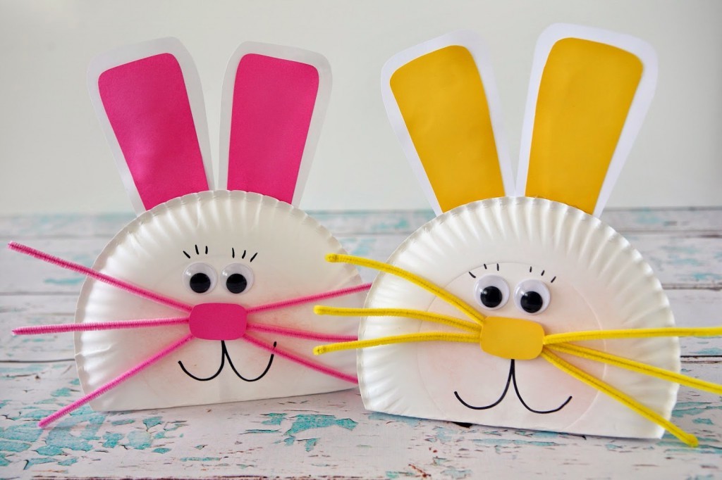 smiling easter bunny faces, made from white paper plates, decorated with hot pink and yellow, paper cutouts and fuzzy wire