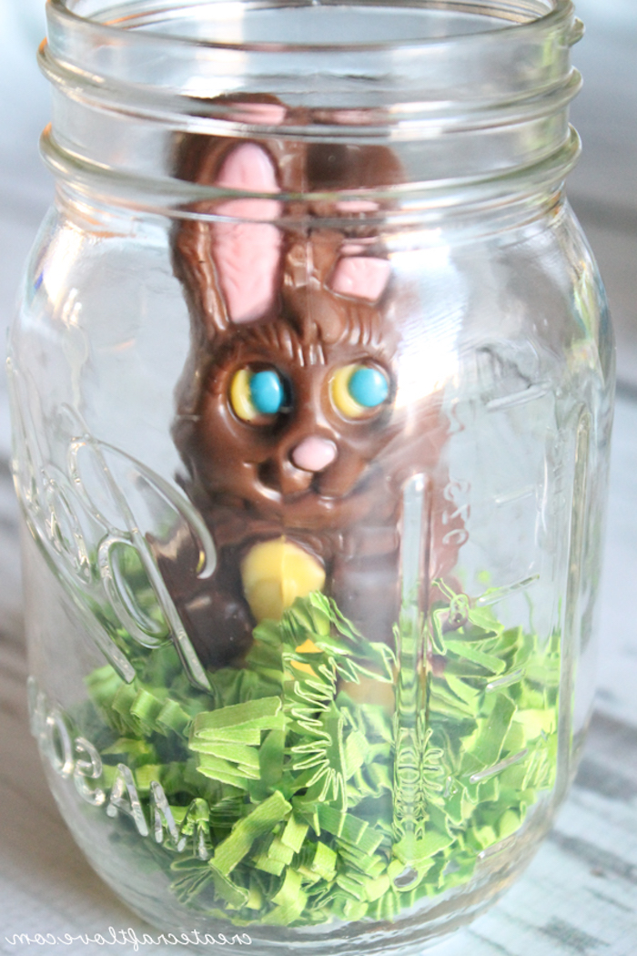 jar filled with pale green, easter grass, made out of paper, and a chocolate bunny, easter projects, easy festive idea