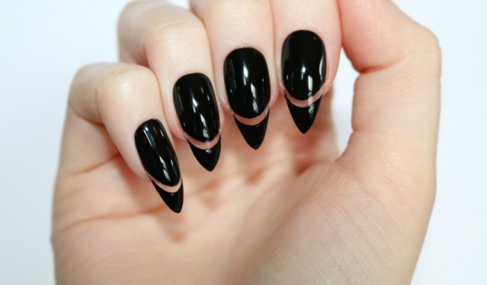 cleverly designed manicure, smooth and shiny, long and sharp, black stiletto nails, with decorative see-through lines