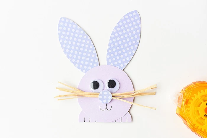 cute rabbit head and paws, made out of pale purple paper, with spotted violet ears, and straw-like whiskers, easter diy 