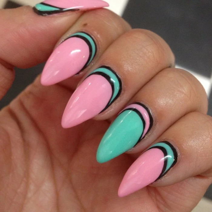 candy pink and turquoise contrasting nail polish, decorated with black lines, on sharp long manicure