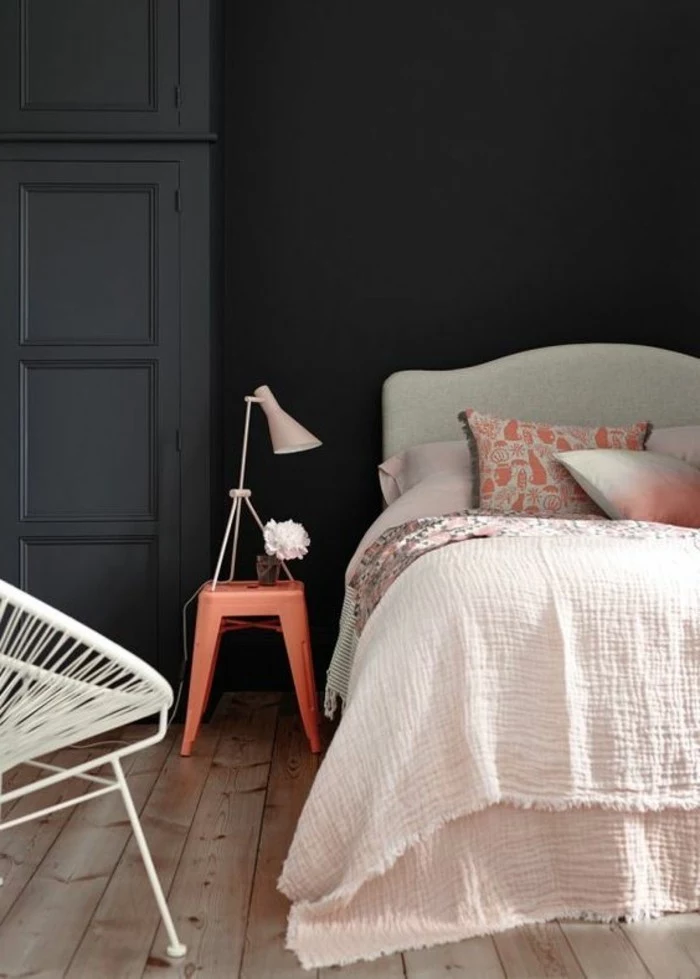 pastel pink and light gray bed, inside black or dark grey bedroom, light wooden floor, small bedside table, and white metal chair, what colours look good with grey