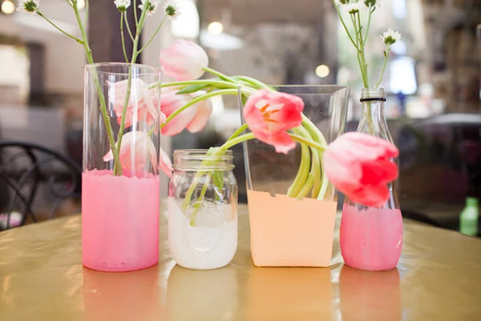 last minute mother's day gift ideas, four dip-dyed flower vases, in pink and white and peach, made from two clear glass containers, used mason jar and bottle