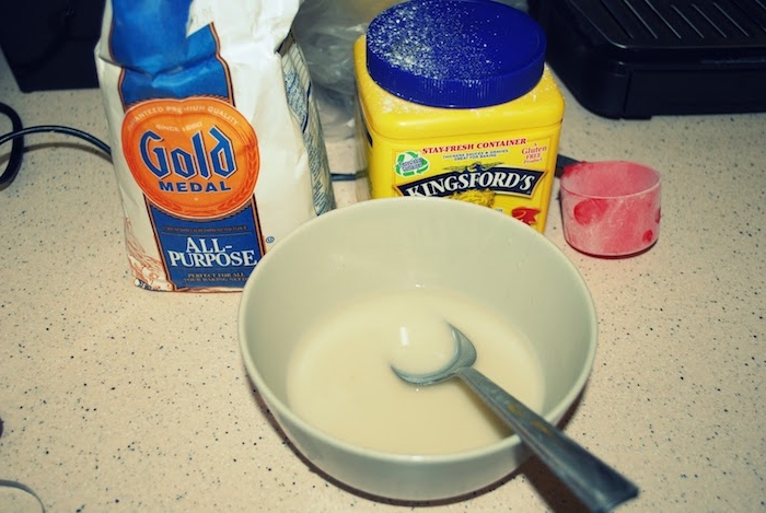 home-made glue, containing white flour, powdered corn starch and water, easter arts and crafts, a pale blue bowl, with metal spoon, red measuring cup