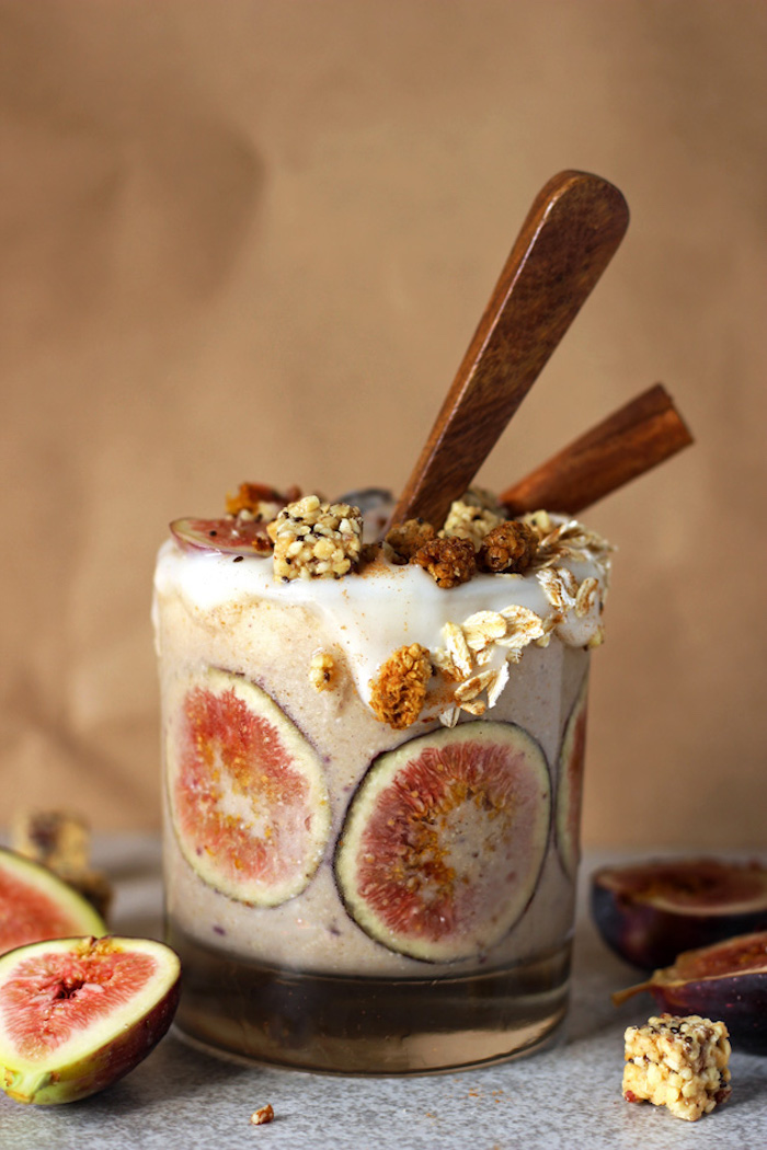 fig slices in clear tumbler, filled with beige creamy liquid, and decorated with crunchy toppings, protein shake recipes