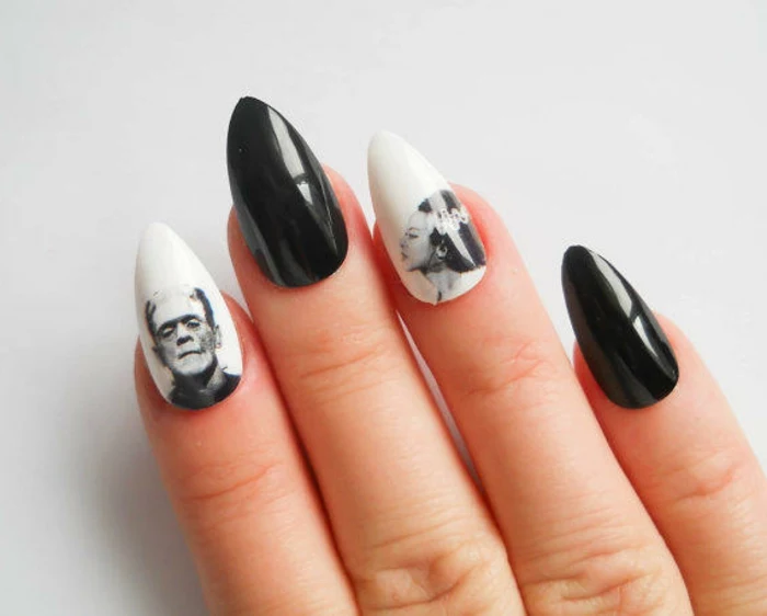 halloween manicure with black and white stickers, of frankenstein and his bride, on sharp stiletto nails, painted in shiny, white and black nail polish