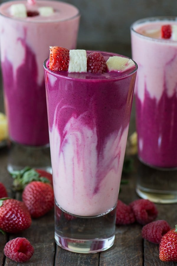 blended drink in purple and pale pink, topped with a strawberry, banana and raspberry kabob, fruit smoothie recipes 