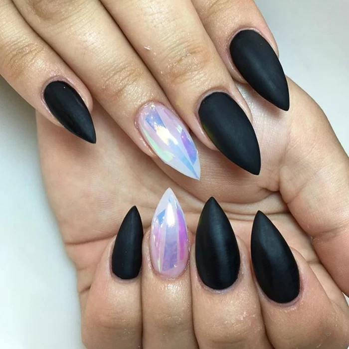 smooth and shiny, gem-like iridescent effect, in pale blue and pink, on black stiletto nails, covered in matte nail polish