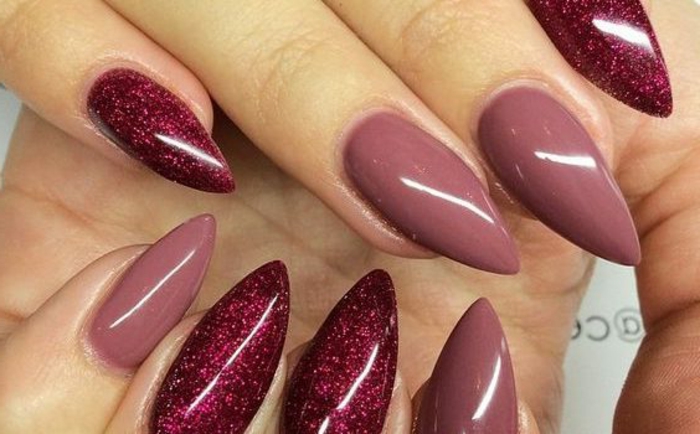 close up of nails, in glittering red, and rose ash pink, sharp oval manicure, chic and understated