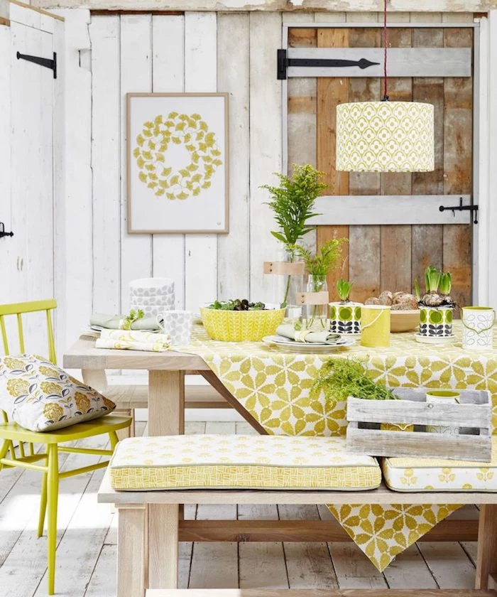 yellowish-green decorations, in a room covered in white wooden planks, wooden dining table and matching bench, acid green vintage chair, country kitchen décor, antique light brown wooden door