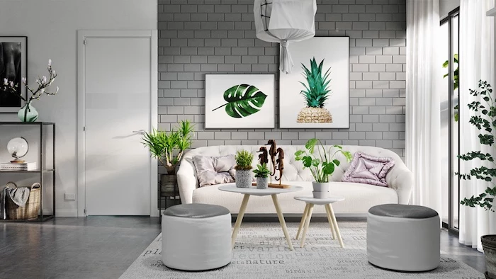 white wall with grey bricks, light cream sofa, living room color ideas, several potted plants, and two large, framed botanical artworks, what colours look good with grey