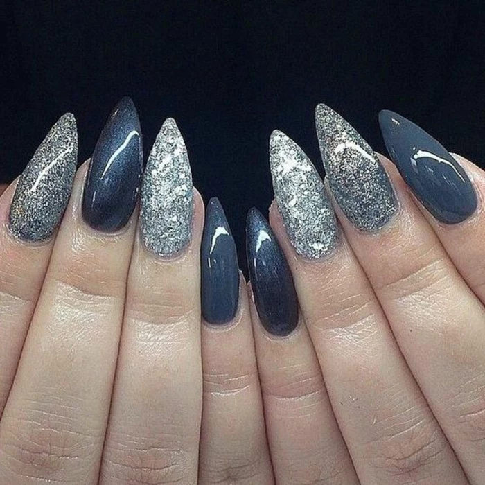 dark bluish-grey manicure, with silver and white glitter, and lead-colored nail polish, on long stiletto nails 