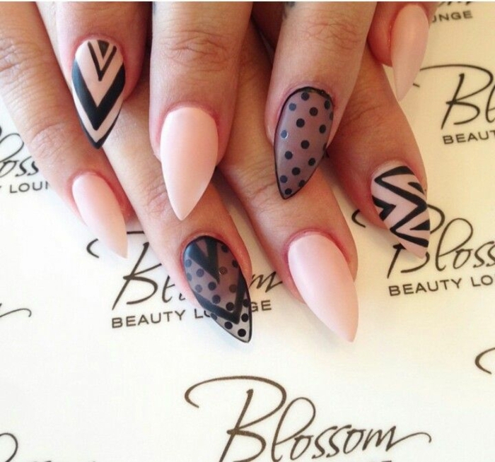 sheer black nail polish, decorated with opaque, black polka dots, on sharp manicure, in pale pink 