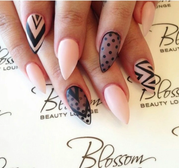 sheer black nail polish, decorated with opaque, black polka dots, on sharp manicure, in pale pink 