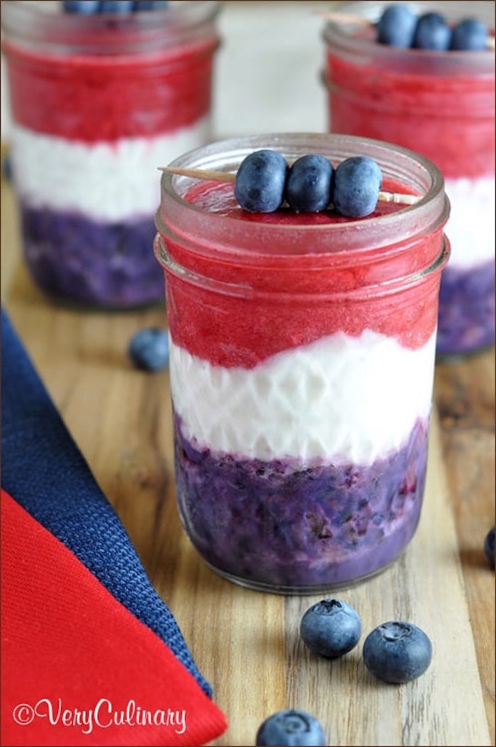 purple and white and pink blended drink, fruit smoothie recipes, poured into three jars, and decorated with blueberry kabobs