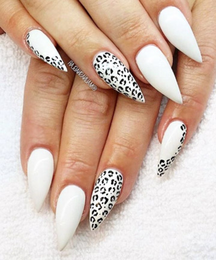 animal printed nails, in white and black, small leopard spots, on sharp and long stiletto nails 
