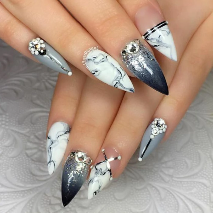 gray nail-polish in differemt combinations, marble effect and ombre, decorated with glitter, rhinestone and metallic stickers, on sharp stiletto nails