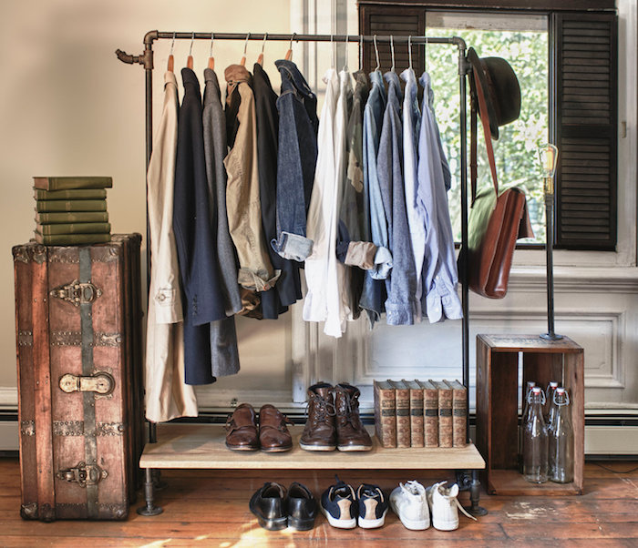 simple clothes rack, made of metal and a wooden shelf, with various clothes items for men, shirts and blazers, leather shoes and sneakers, alternative to closet