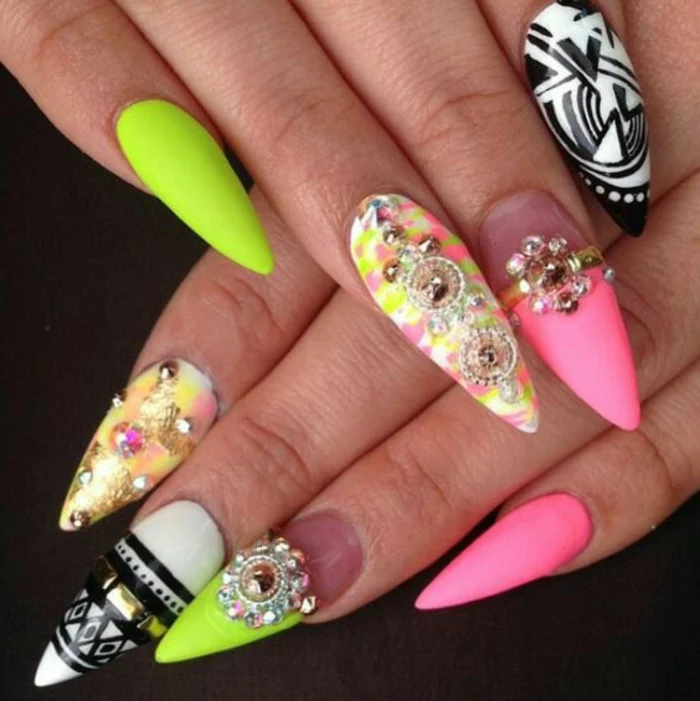 bright multicolored claw nails, kitsch mix of neon colors, bright acid green and pink, black and white, various rhinestone stickers 