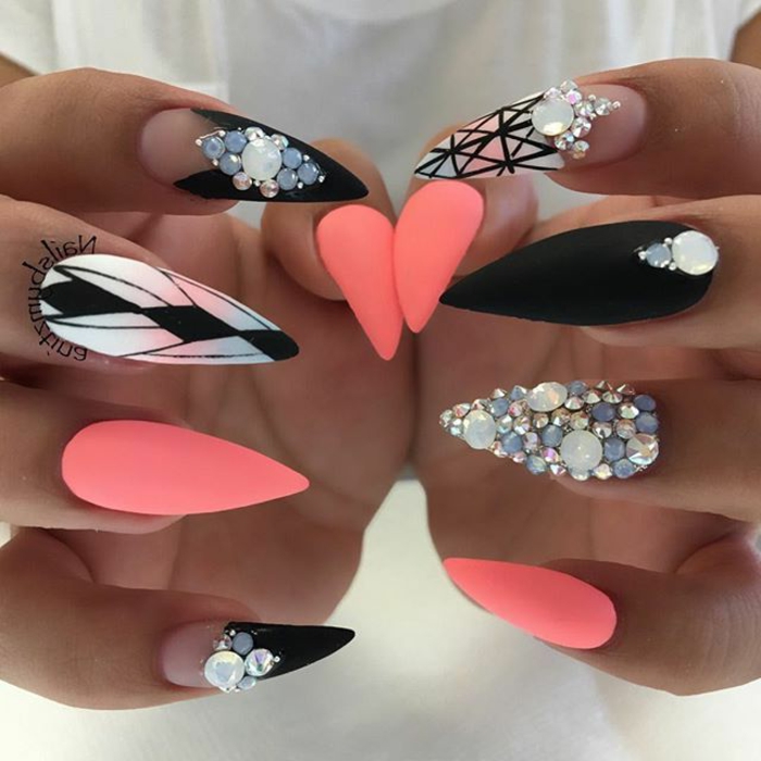 light neon pink, and black stiletto nails, with clear nail polosh details, hand-drawn geometric patterns, pearl and rhinestone stickers