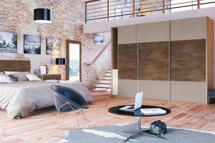 industrial style brown and grey bedroom, in open-plan penthouse flat, light laminate floor, grey animal skin rug, brick-wall design