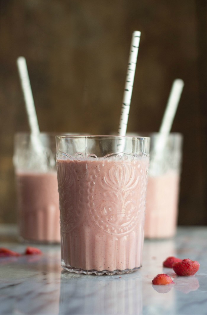 pastel pink blended liquid, poured in three ornate glasses, protein shake recipes, with decorative paper straws