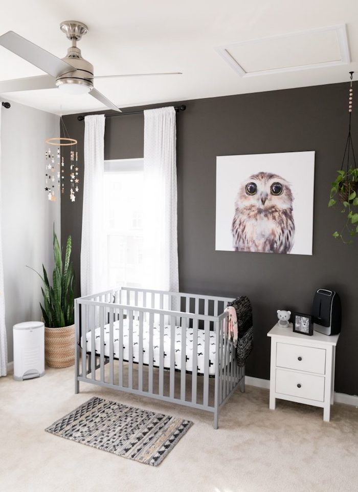 dark brown and white walls, light gray crib with white bedding, gender neutral nursery, painting of adorable owl, light beige floor
