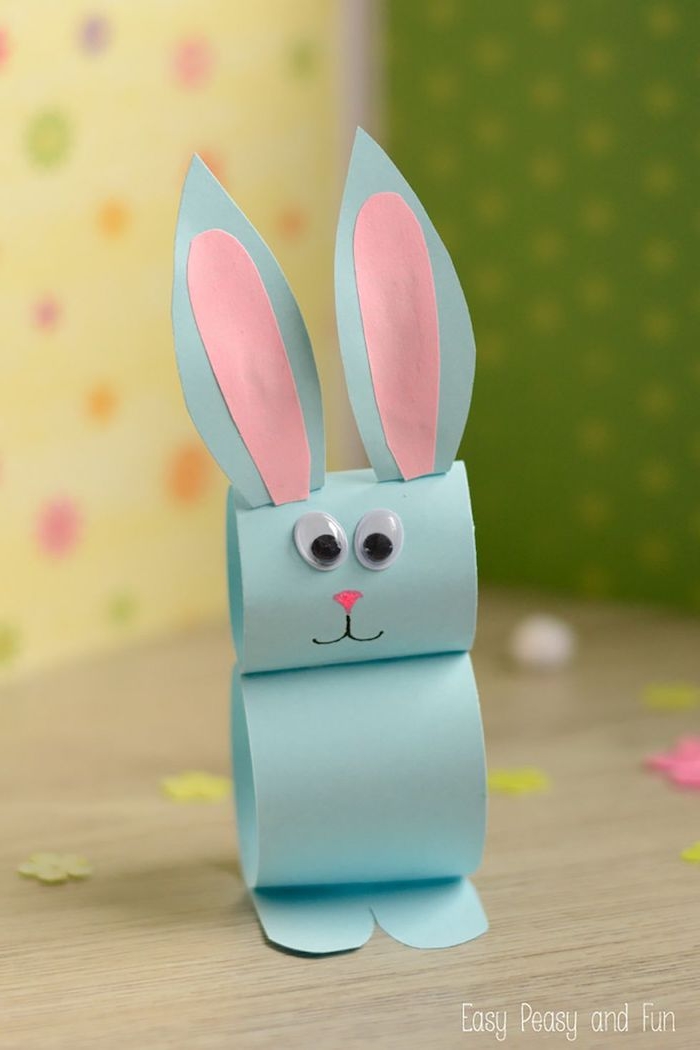 pale blue paper craft bunny, with pink ear details, googly eye stickers, and hand-drawn nose and mouth