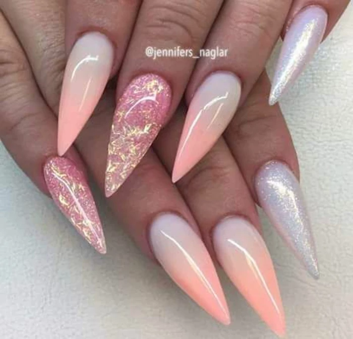 ombre-effect sharp and long, stiletto acrylic nails, in pale pastel blue and pink, decorated with silver and pink glitter