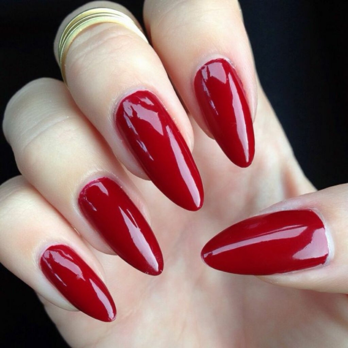 chic red manicure, glossy deep color, on oval long stiletto nails, perfect classic look