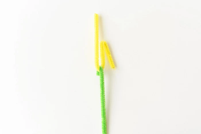fuzzy wire in yellow and green, attached to each other, to form a flower stalk, easter diy, simple festive decoration