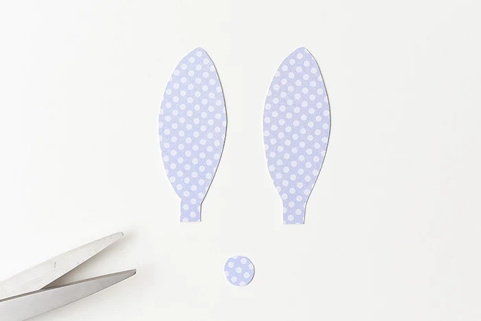 rabbit's ears and round nose, cut out from pale violet paper, with light polka dots, craft ideas for kids, metal scissors nearby